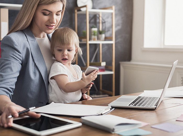 woman working with baby on her lap
